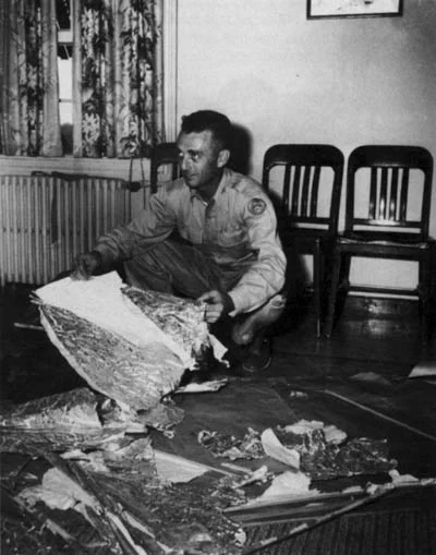 Jesse Marcel posa segurando pedaços de um balão para a segunda versão oficial do Caso Roswell